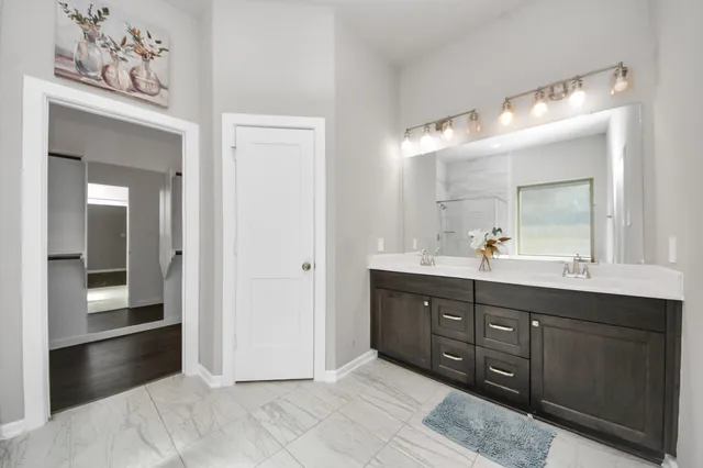a en suite bathroom with a sink mirror and vanity