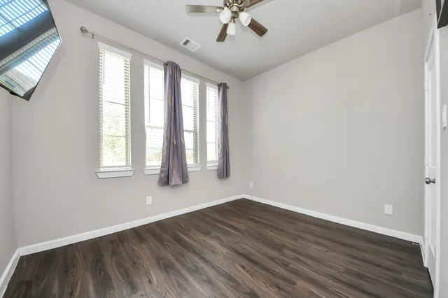 wooden floor in an empty room with a window