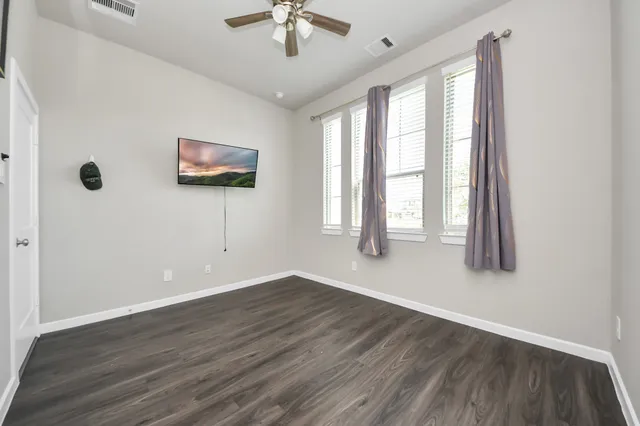 a bathroom with a sink vanity mirror and toilet