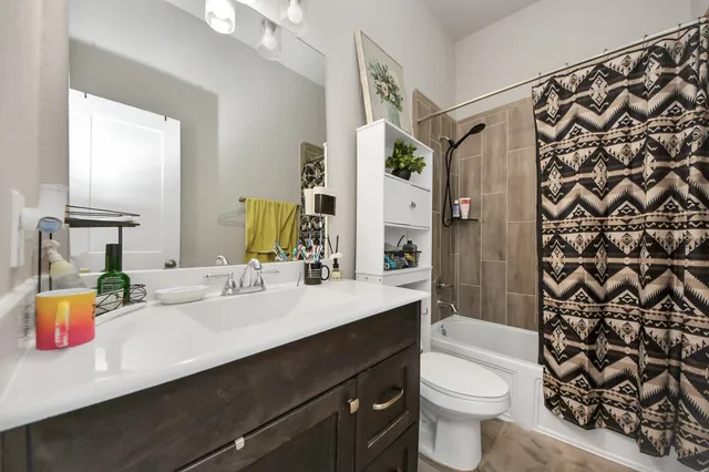 a bed room with a bed window and a flat screen tv