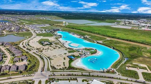 an aerial view of a house a yard swimming pool and outdoor seating