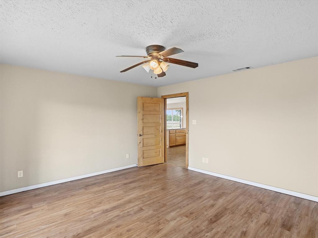 6568 Michael Road Sanger, TX 76266 - Photo 12 of 33 a view of room with hardwood floor and ceiling fan