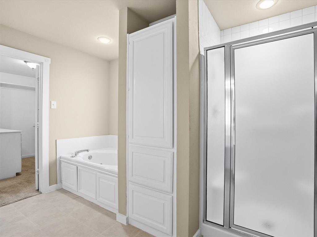 6568 Michael Road Sanger, TX 76266 - Photo 14 of 33 a bathroom with a tub sink and shower