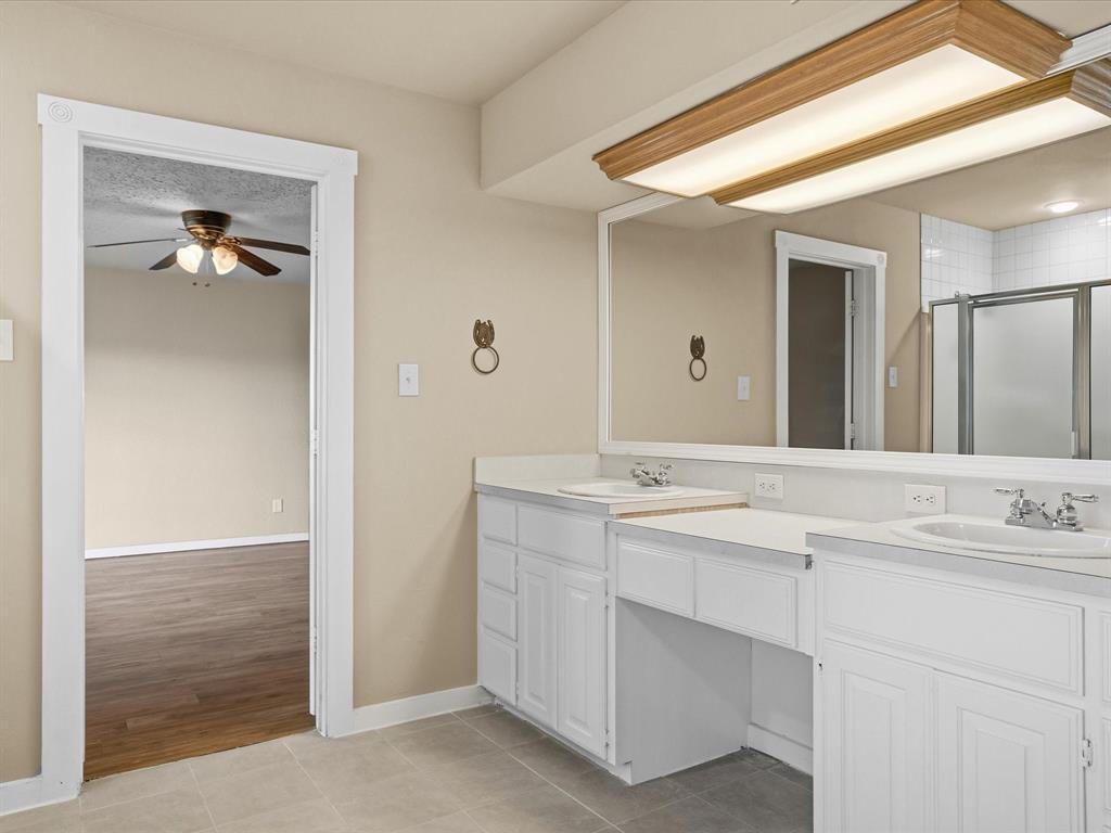 6568 Michael Road Sanger, TX 76266 - Photo 15 of 33 a bathroom with a sink and a mirror