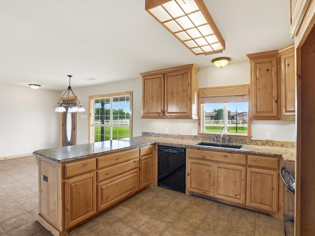 6568 Michael Road Sanger, TX 76266 - Photo 10 of 33 a kitchen with sink cabinets and window