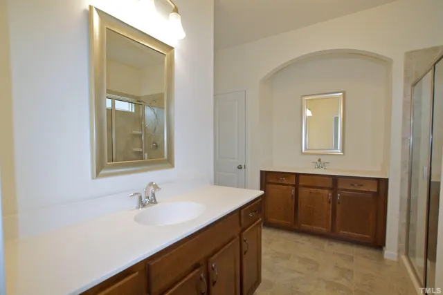 a bathroom with a sink vanity and mirror