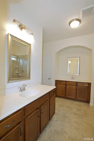 a bathroom with a sink vanity and mirror