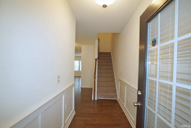 a view of a hallway with wooden floor and entryway