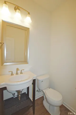 a bathroom with a sink a toilet and mirror