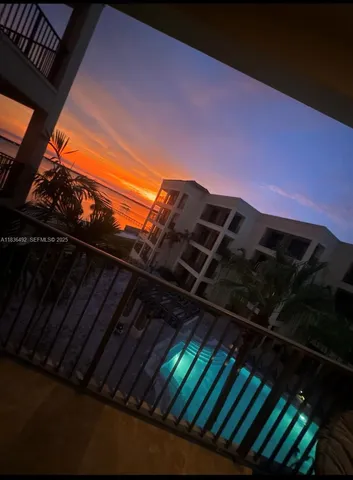 a view of a terrace with lawn chairs