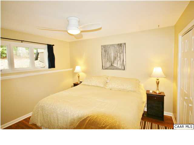 456 Three Ridges Roseland, VA 22967 - Photo 5 of 8 a bedroom with a bed and a lamp