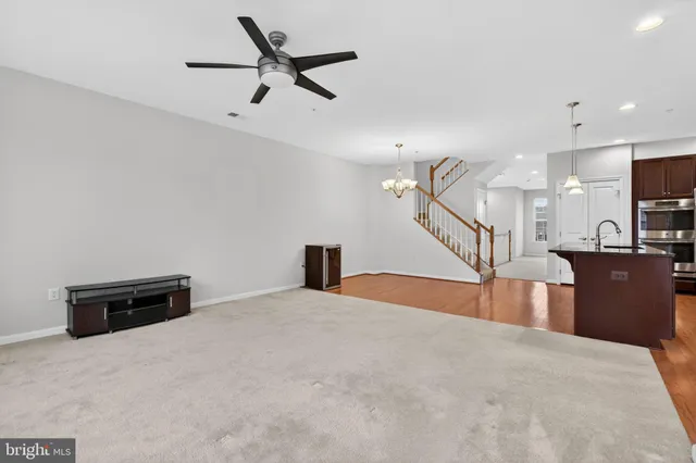 a view of a livingroom with a furniture and a ceiling fan