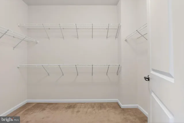 a kitchen with kitchen island a counter top space a sink stainless steel appliances and cabinets