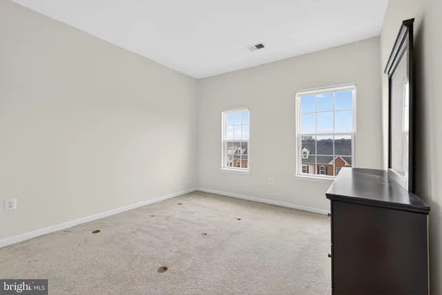 a room with a dresser and mirror