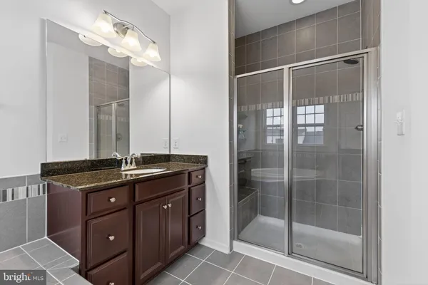 a bathroom with a double vanity sink mirror and toilet