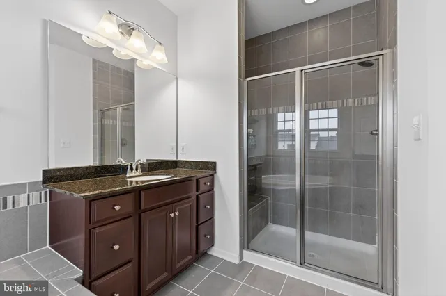 a bathroom with a double vanity sink mirror and toilet