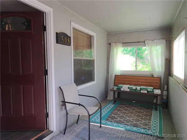 a living room with furniture and a rug