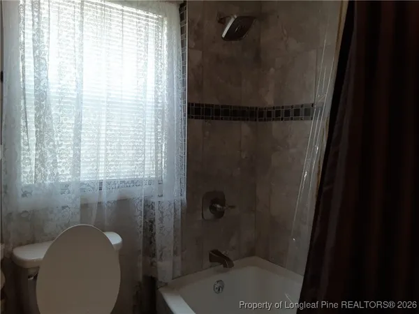 a bathroom with a shower and a toilet