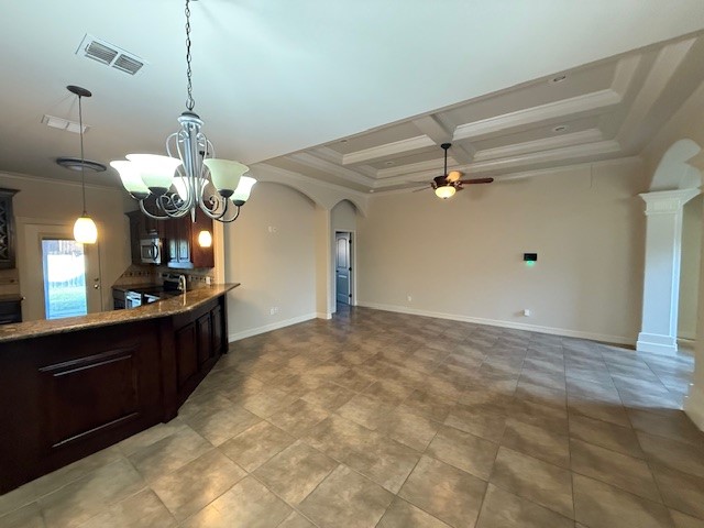 6933 Spring Wind Corpus Christi, TX 78413 - Photo 2 of 11 a kitchen with kitchen island a chandelier and living room view