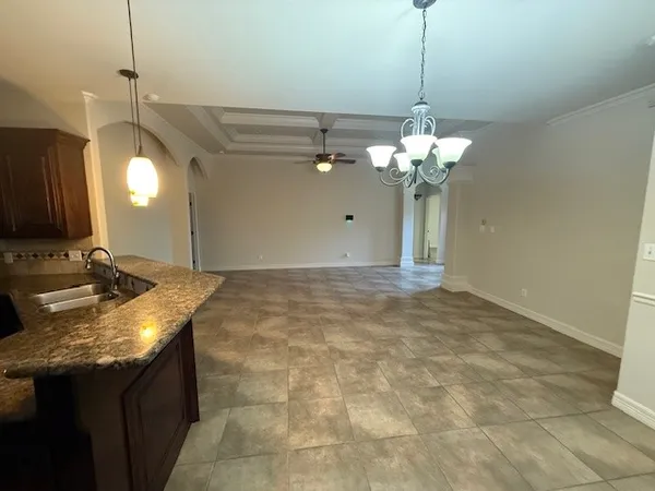 a view of a kitchen with a sink and chandelier