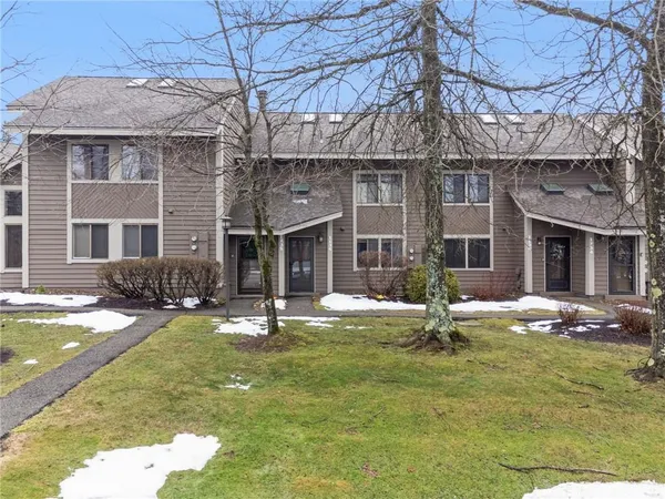 a view of a house with swimming pool and sitting area