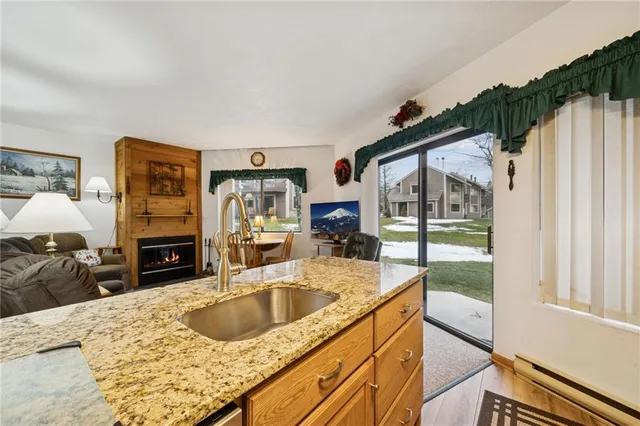 a kitchen with granite countertop a sink stove and refrigerator