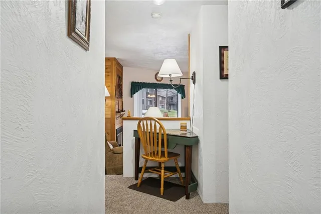 a view of a room with a table and chairs