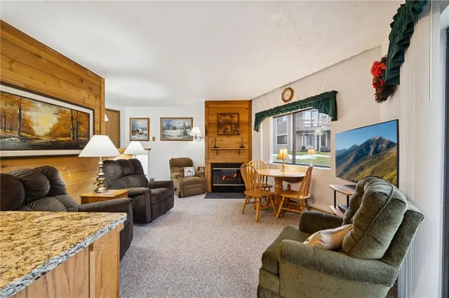 a living room with furniture fireplace and a flat screen tv