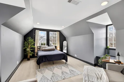 a bedroom with a large bed and a window