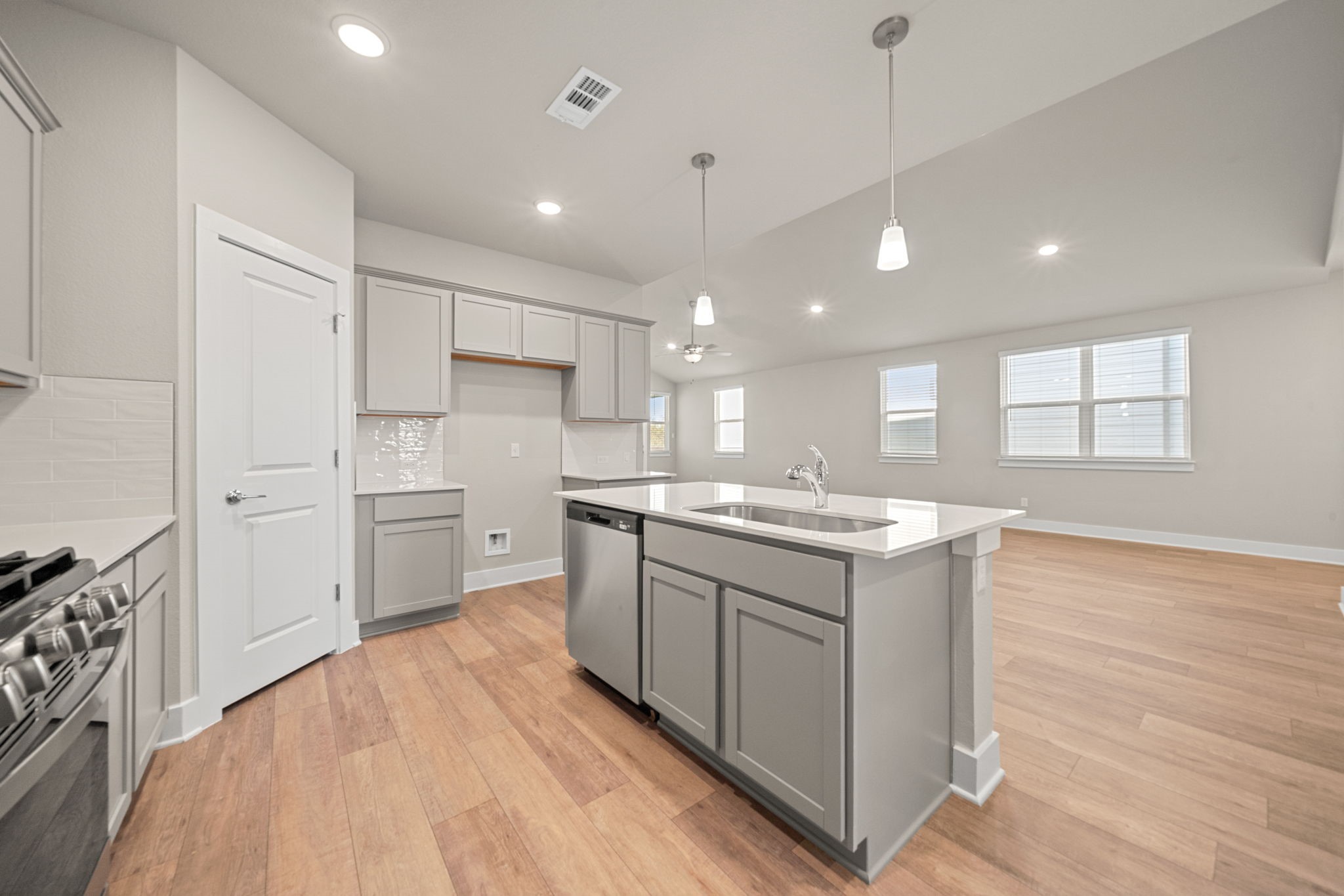 219 Pinnacle Lane Kyle, TX 78640 - Photo 18 of 20 a kitchen with a sink window and stainless steel appliances