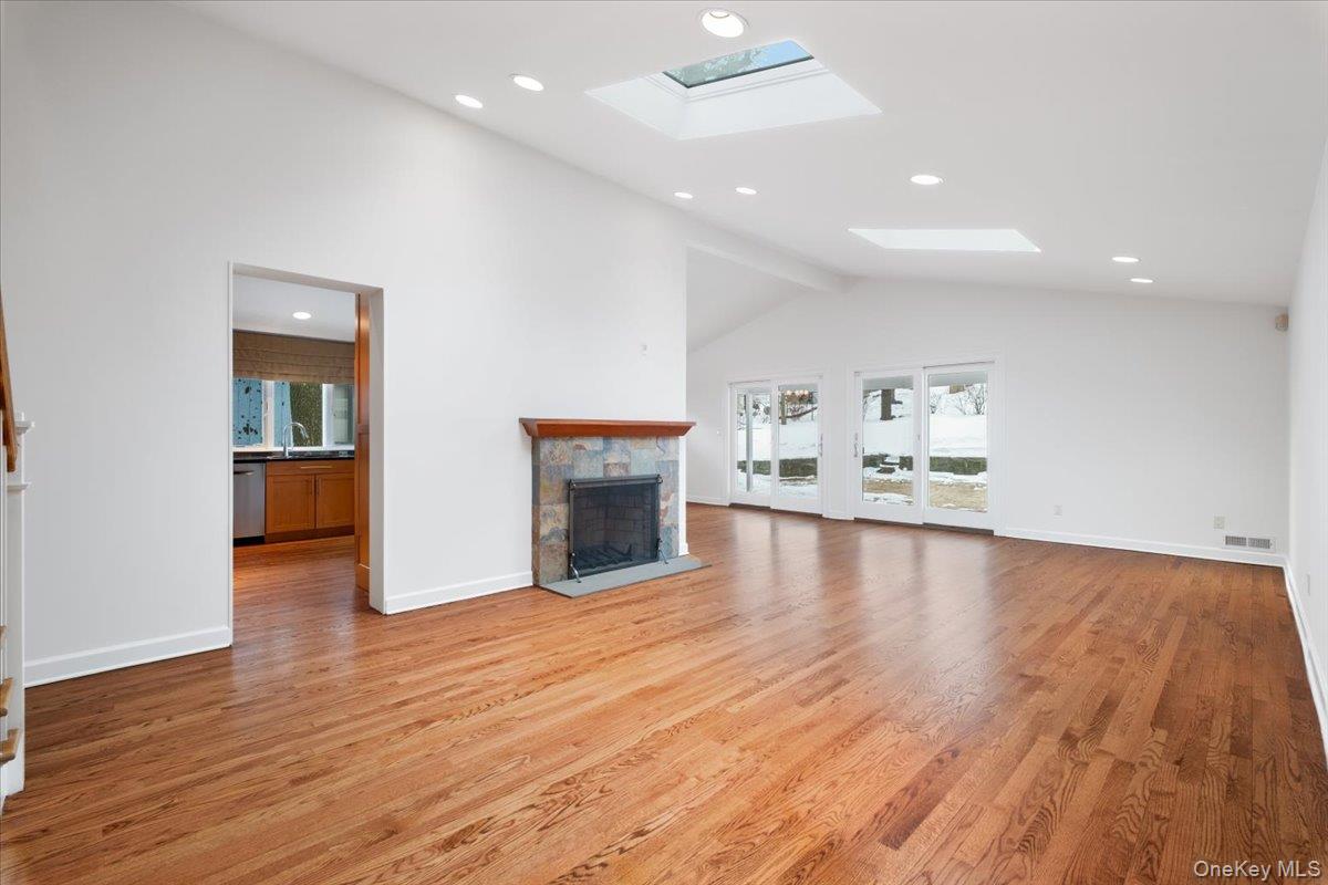 9 Tanglewood Road Scarsdale, NY 10583 - Photo 11 of 33 a view of empty room with wooden floor and fireplace