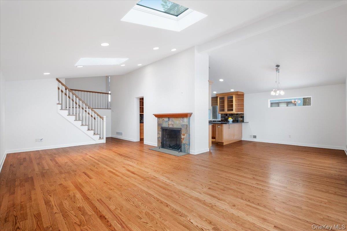 9 Tanglewood Road Scarsdale, NY 10583 - Photo 12 of 33 a view of empty room with wooden floor and fireplace