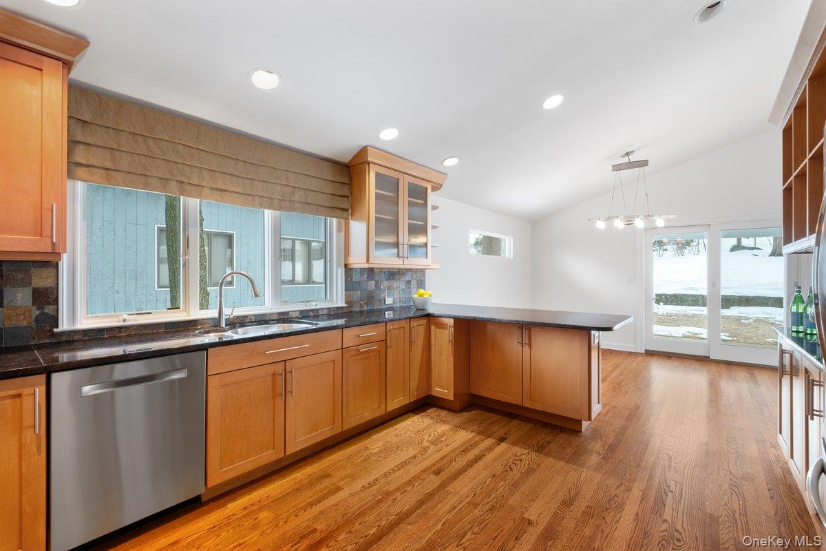 9 Tanglewood Road Scarsdale, NY 10583 - Photo 17 of 33 a kitchen with stainless steel appliances granite countertop wooden floors and view living room