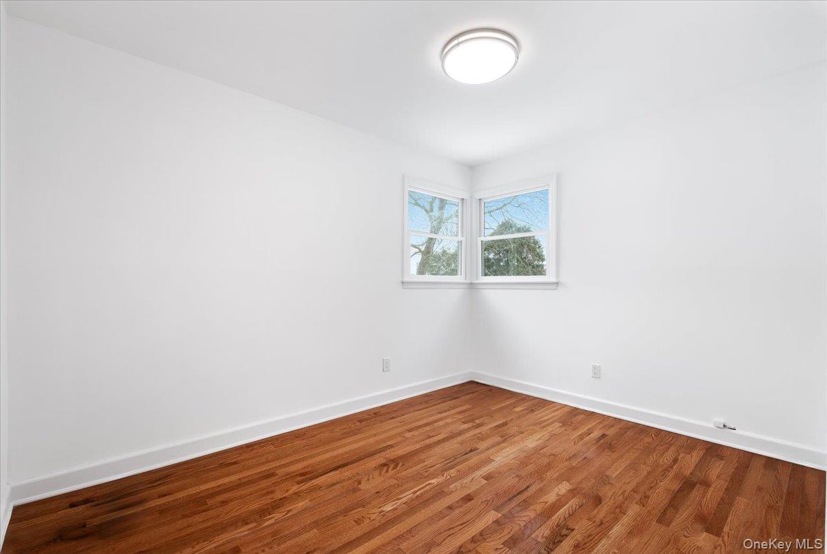 9 Tanglewood Road Scarsdale, NY 10583 - Photo 20 of 33 an empty room with wooden floor and windows
