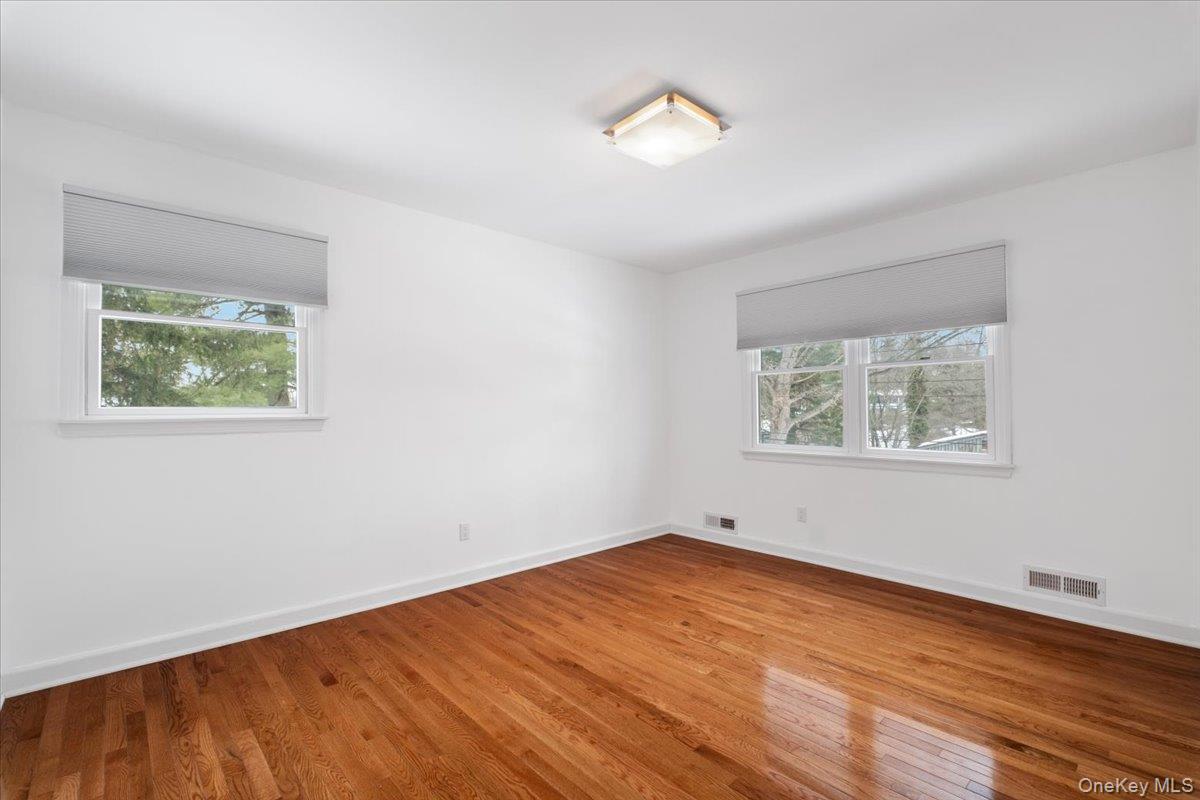 9 Tanglewood Road Scarsdale, NY 10583 - Photo 22 of 33 a view of an empty room with wooden floor and a window