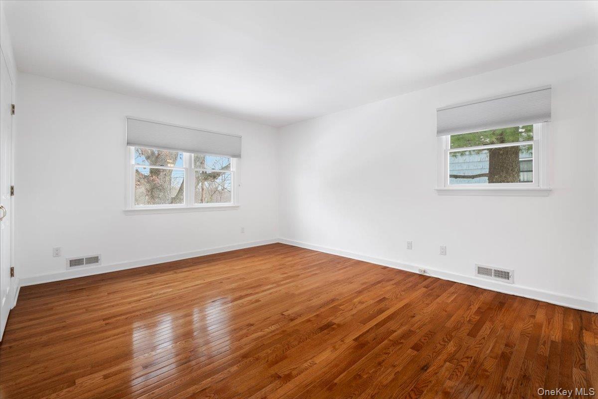 9 Tanglewood Road Scarsdale, NY 10583 - Photo 23 of 33 an empty room with wooden floor and windows