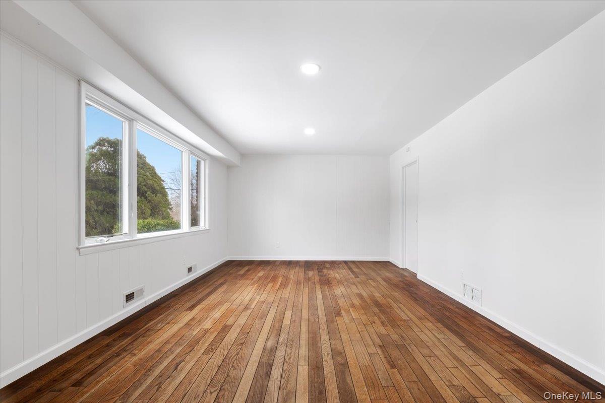 9 Tanglewood Road Scarsdale, NY 10583 - Photo 5 of 33 a view of an empty room with wooden floor and a window