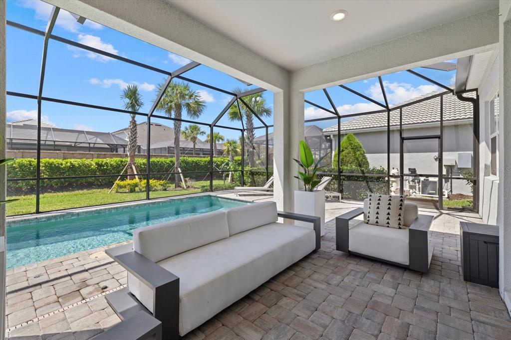 3508 Anchor Bay Trail Lakewood Ranch, FL 34211 - Photo 39 of 74 a living room with couch and a floor to ceiling window