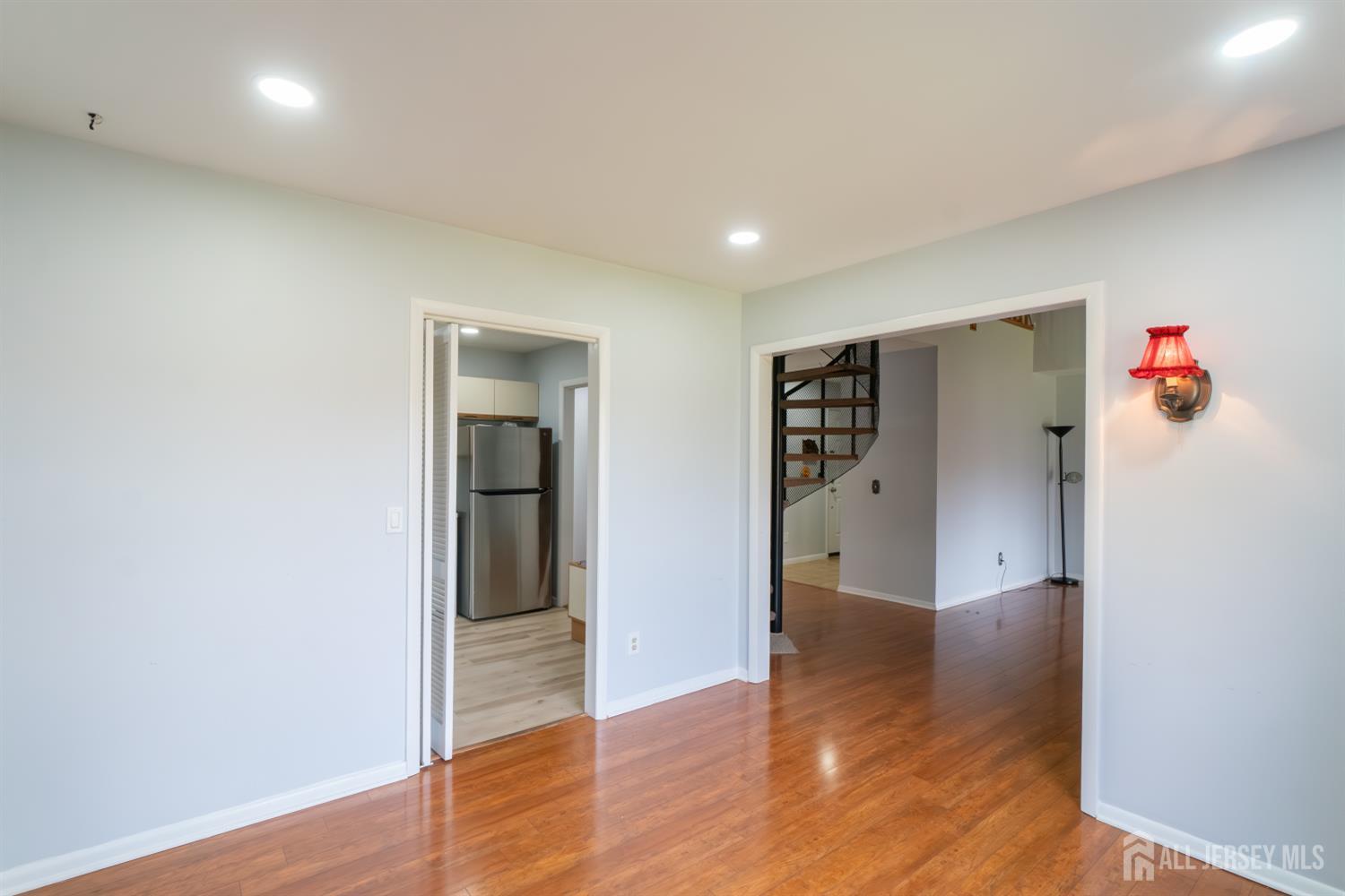 166 Hidden Hollow Court Edison, NJ 08820 - Photo 12 of 36 a view of an empty room with wooden floor and closet