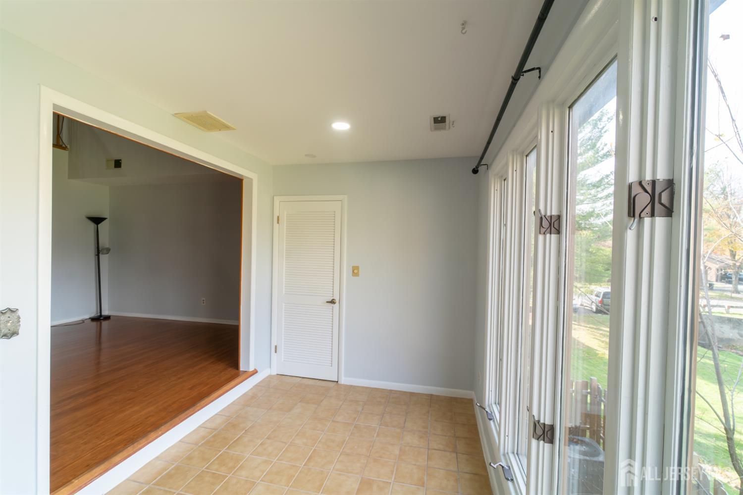 166 Hidden Hollow Court Edison, NJ 08820 - Photo 13 of 36 a view of hallway with a large window and wooden floor