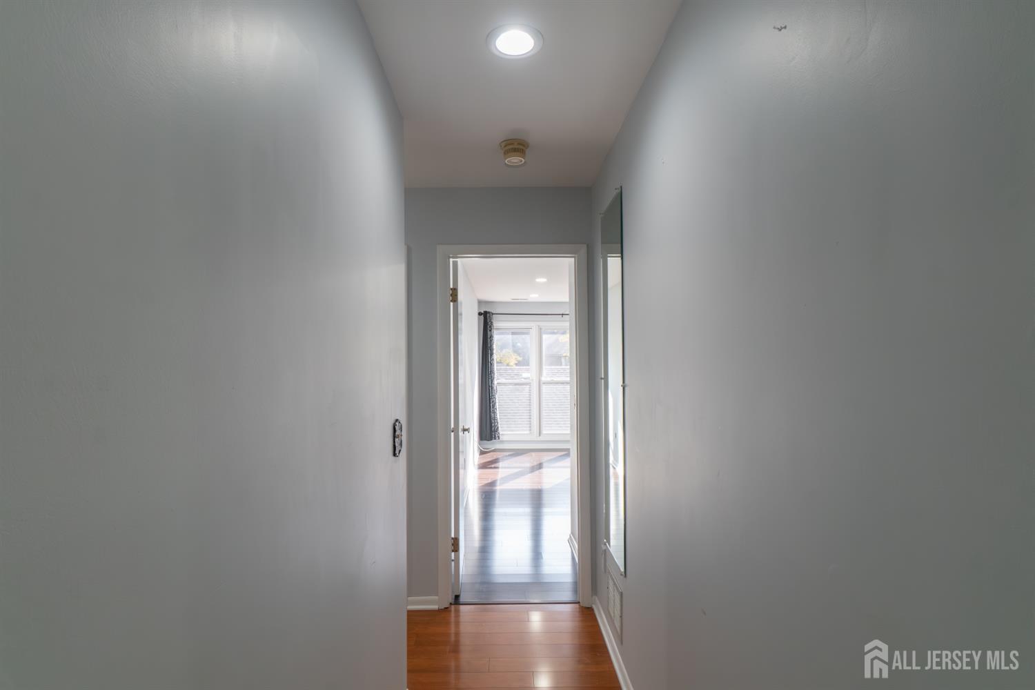 166 Hidden Hollow Court Edison, NJ 08820 - Photo 15 of 36 a view of a hallway with wooden floor and a bathroom