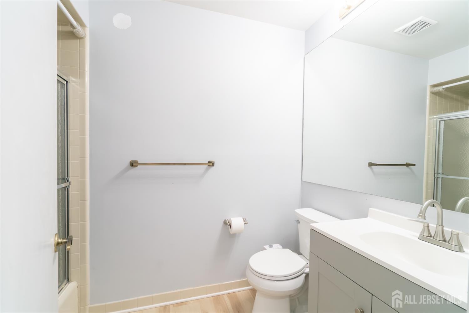 166 Hidden Hollow Court Edison, NJ 08820 - Photo 17 of 36 a bathroom with a granite countertop toilet and a sink