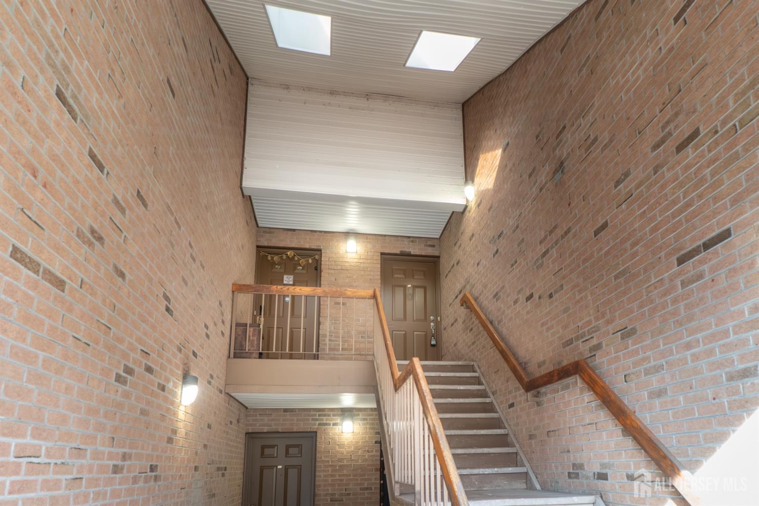 166 Hidden Hollow Court Edison, NJ 08820 - Photo 2 of 36 a view of staircase with railing and white walls