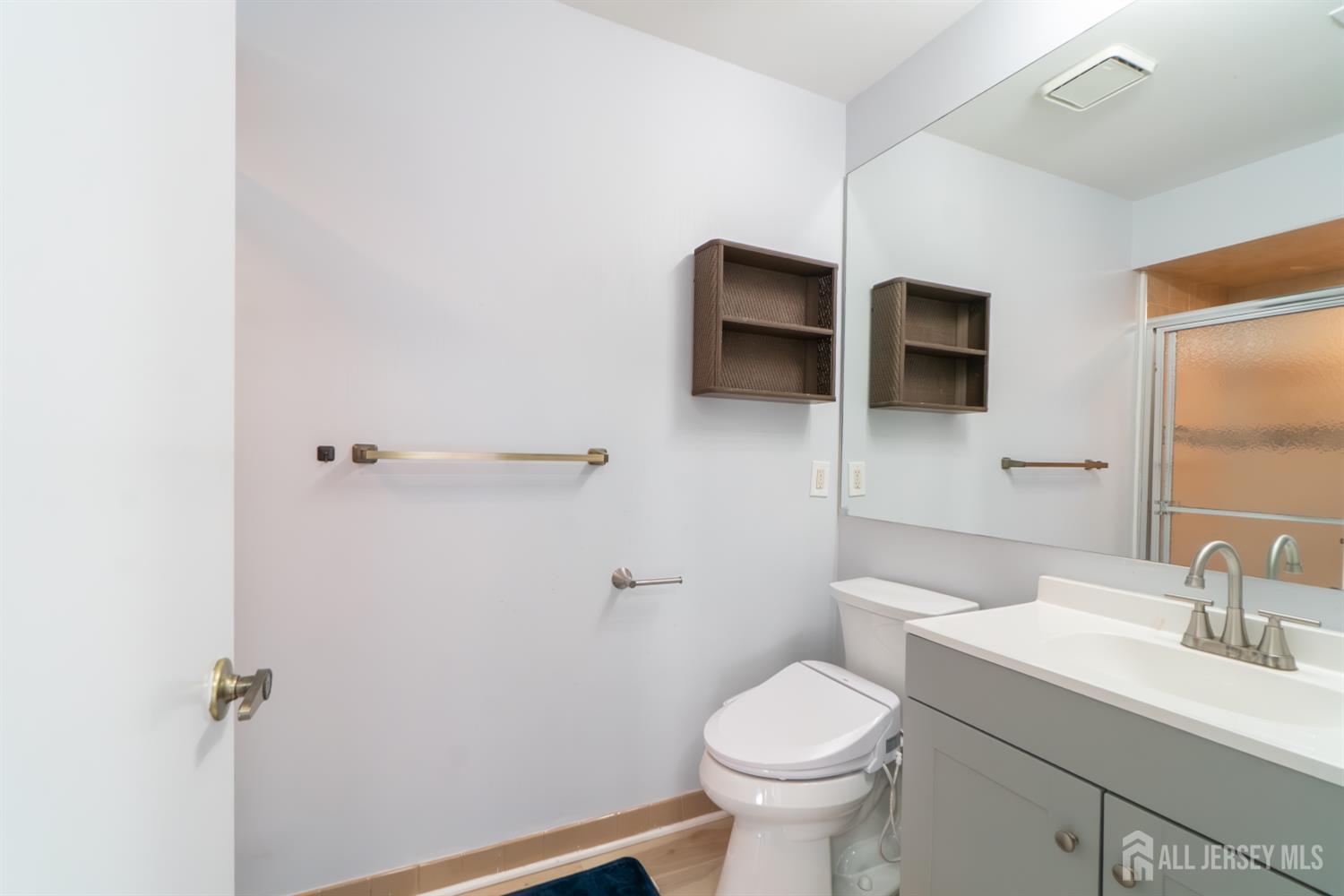 166 Hidden Hollow Court Edison, NJ 08820 - Photo 22 of 36 a bathroom with a sink a toilet a mirror and shower