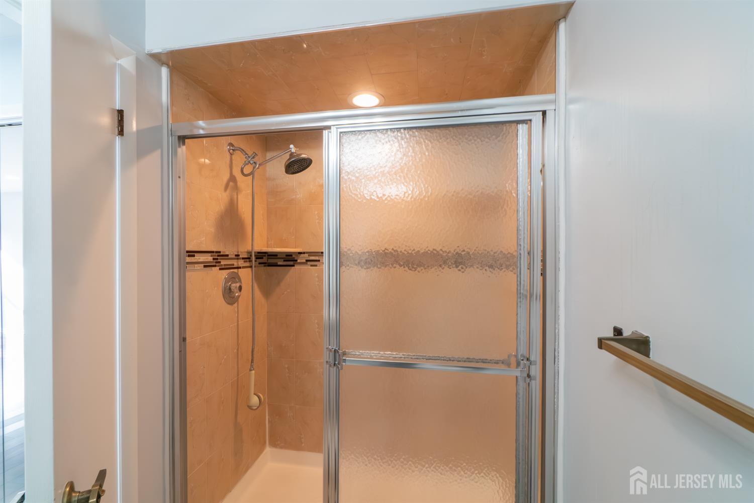 166 Hidden Hollow Court Edison, NJ 08820 - Photo 23 of 36 a bathroom with a glass shower door