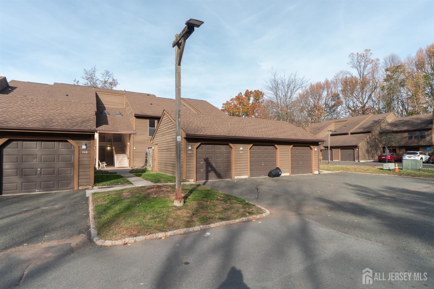 166 Hidden Hollow Court Edison, NJ 08820 - Photo 36 of 36 a front view of a house with a yard and garage