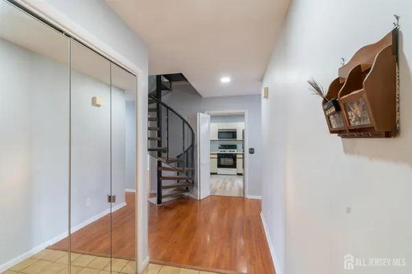 a view of empty room with wooden floor