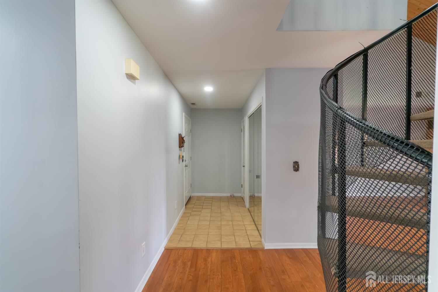 166 Hidden Hollow Court Edison, NJ 08820 - Photo 5 of 36 a view of a hallway with wooden floor and staircase
