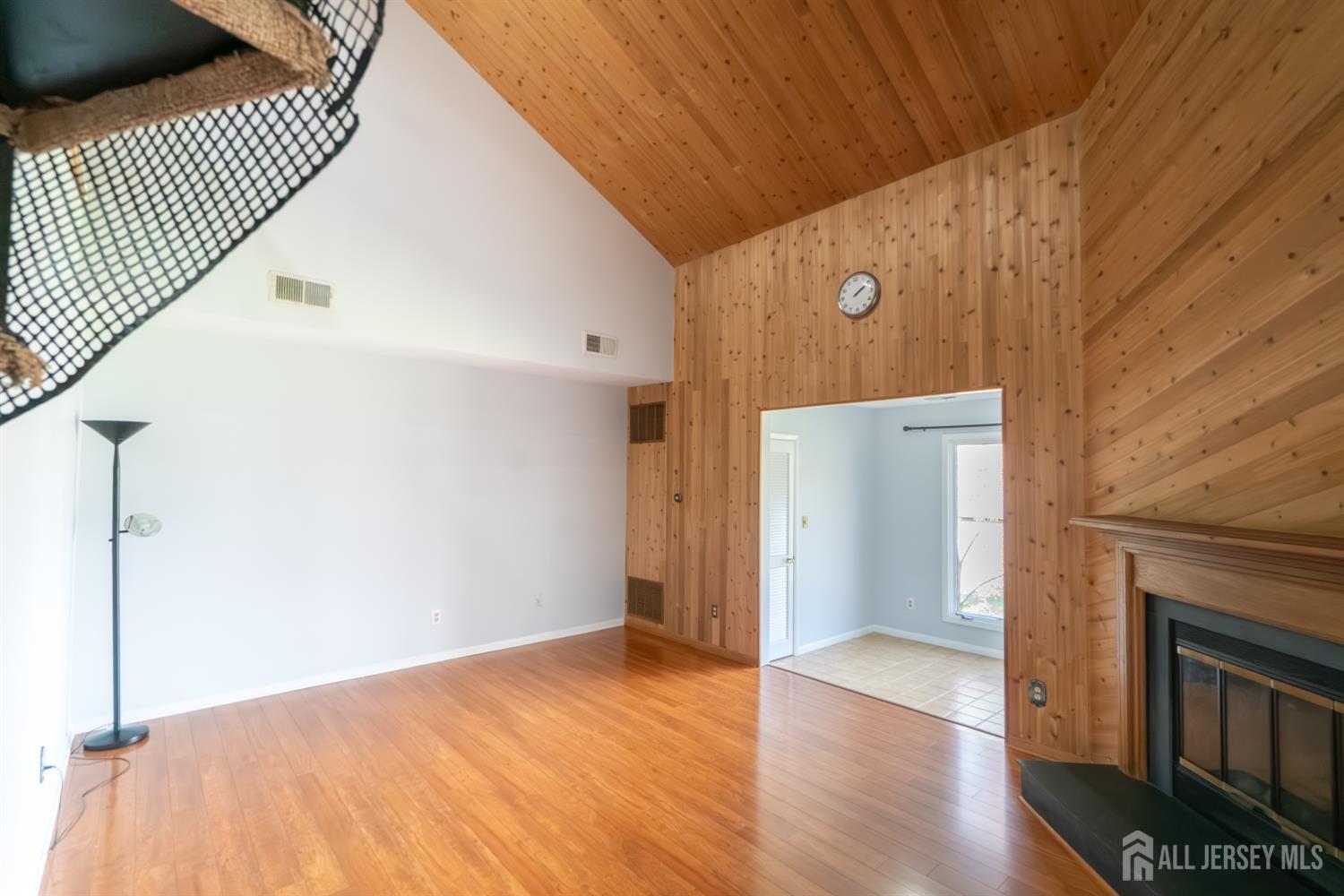 166 Hidden Hollow Court Edison, NJ 08820 - Photo 6 of 36 a view of a livingroom with wooden floor and a ceiling fan