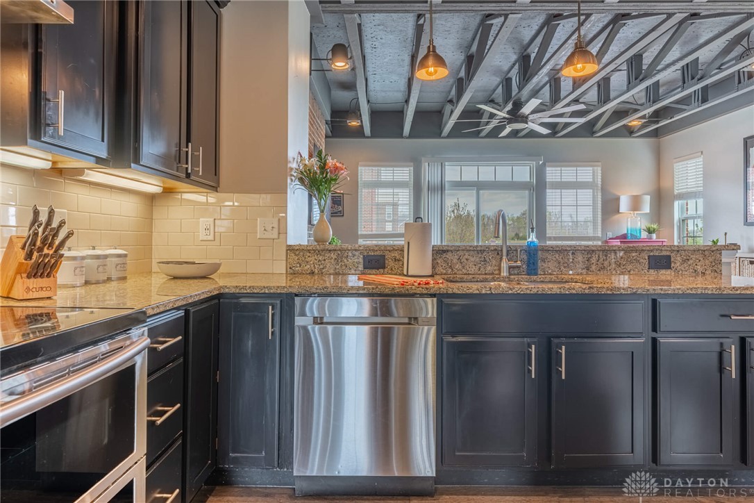 407 Brownstone Row Springboro, OH 45066 - Photo 16 of 54 This kitchen features a bright ambiance with exposed beams and modern appliances.